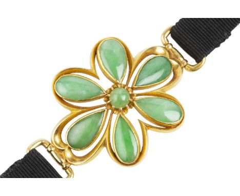 A jade panel bracelet, designed as a convex openwork flowerhead panel, with a cluster of round and pear-shaped jadeite caboch