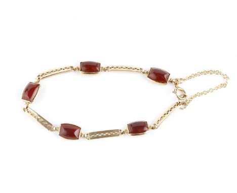 A carnelian panel bracelet, designed as a series of rectangular panels with pierced geometric decoration, spaced by carnelian