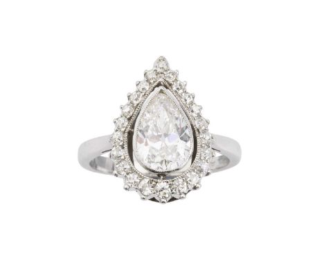 A diamond cluster ring, the pear-shaped old brilliant-cut diamond in millegrain collet setting, to a border of graduated sing