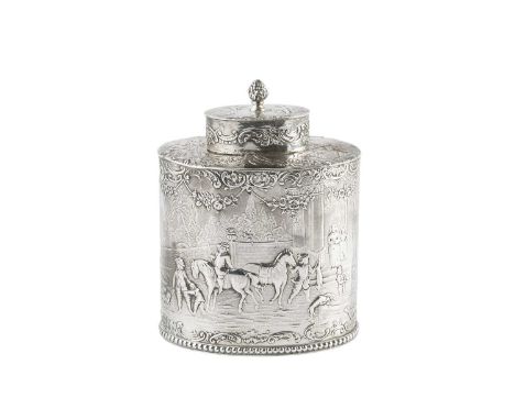 A late 19th century German (Hanau) silver tea caddy and cover, of oval form, embossed with a continuous scene of figures and 