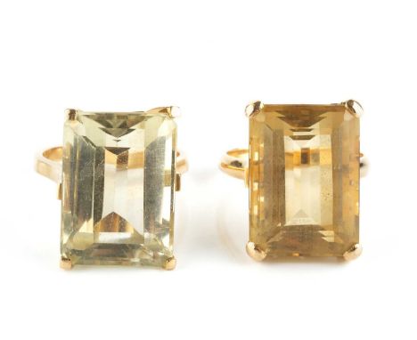 Two citrine single stone dress rings, each with a rectangular step-cut citrine in four claw setting, yellow precious metal mo