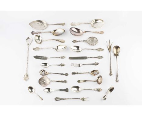 A collection of American silver flatware, comprising four various serving spoons/slices, a pair of table spoons with portrait