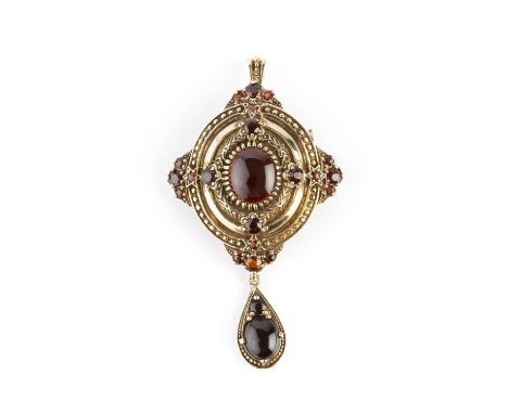 A garnet set pendant/brooch, the shaped oval panel with bead accents, centred with an oval cabochon garnet bordered by smalle