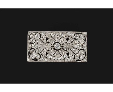 An Art Deco style diamond panel brooch, the rectangular panel pierced with stylised foliate and anthemion motifs, millegrain 