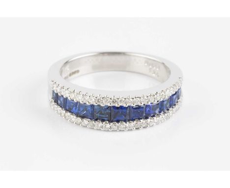 A sapphire and diamond half hoop ring, centred with a channel of graduated square mixed-cut sapphires, between two rows of ro