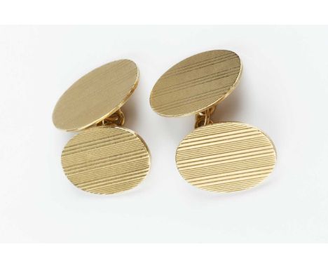 A pair of 9ct gold cufflinks, the oval panels with engine-turned decoration, on chain-link fittings, hallmarked for Chester 1