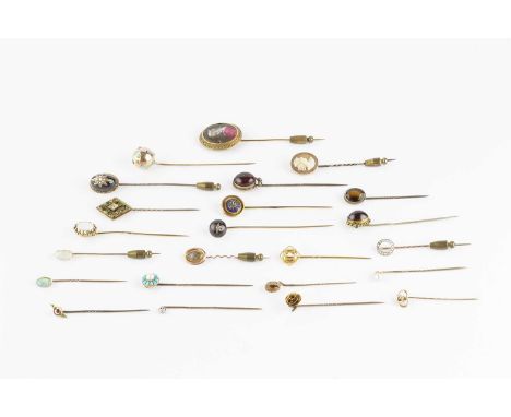 A collection of antique and later stick pins, comprising a diamond circlet stick pin, a diamond set lover's knot stick pin, a