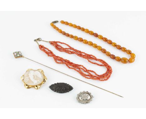 A collection of jewellery, comprising an oval shell cameo brooch, the foliate scroll decorated mount stamped '18CT', a coral 