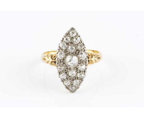 A diamond panel ring, the navette-shaped panel pavé set with graduated old and single-cut diamonds, between scroll engraved s