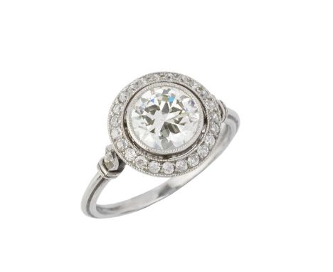 A diamond cluster ring, the transitional round brilliant-cut diamond in millegrain collet setting, to a similarly set border 
