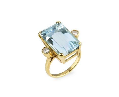 An aquamarine and diamond three stone ring, the rectangular step-cut aquamarine claw set between two round brilliant-cut diam