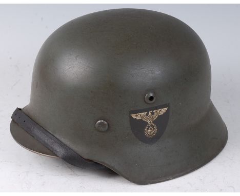 A post WW II German M35 steel helmet, having RAD decals with leather liner and chin strap.