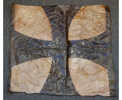 A large patch of canvas painted with an Imperial German Cross, possibly removed from an aeroplane, 56 x 62cm.