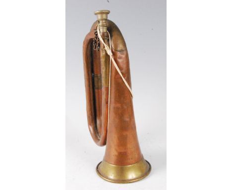 A copper and brass bugle stamped Nadir Ali &amp; Co. Meerut, 1941.