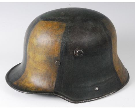 A German 1916 pattern helmet in camouflage finish with leather liner, stamped to the interior R1155.