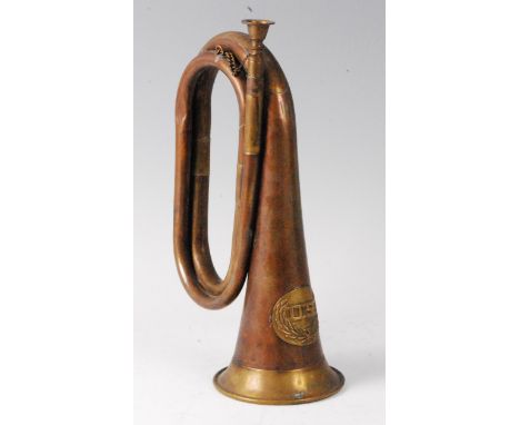 A brass and copper bugle with applied U.S. crest.