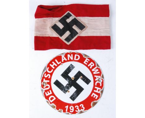 A German N.S.D.A.P. party members armband, together with a Deutschland Erwache (Germany awake) 1933 enamel sign. (2)