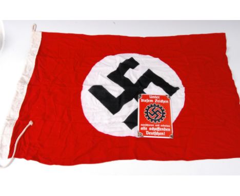 A German N.S.D.A.P. flag, stamped to the lanyard RZM Munchen N.S.D.A.P. and dated 1943, 55 x 100cm, together with an enamel s