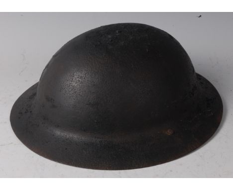 A British Brodie pattern helmet, with 1st type leather liner, stamped to the interior 18 245.