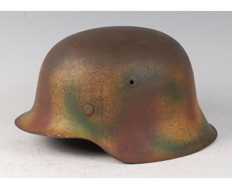 A post WW II German M42 helmet, in camouflage finish with leather liner.