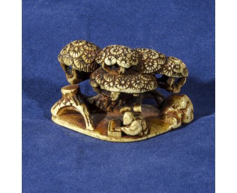 An ivory netsuke modelled as a scribe sat underneath a tree