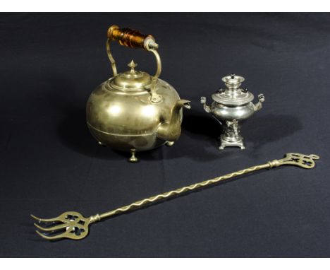 A brass kettle with amber glass handle, a mini samovar and a brass toasting fork