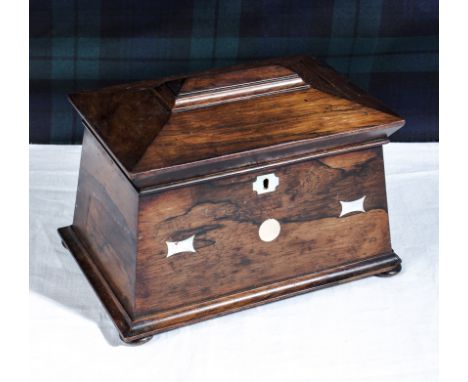 A rosewood tea caddy with mother of pearl inlay