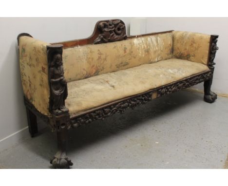 19TH CENTURY OAK SHOW FRAME CARVED UPHOLSTERED SOFA, having raised cresting carved with cherub upon seahorse, the upholstered