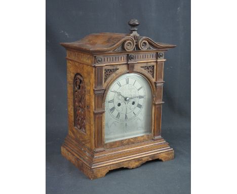EARLY 20TH CENTURY WALNUT TWO TRAIN ARCHITECTURAL BRACKET CLOCK having arched silvered foliate engraved face with Roman numer
