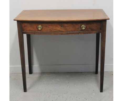 EARLY 19TH CENTURY MAHOGANY BOW FRONTED SIDE TABLE with cross banded top and single frieze drawer on square tapering legs. No