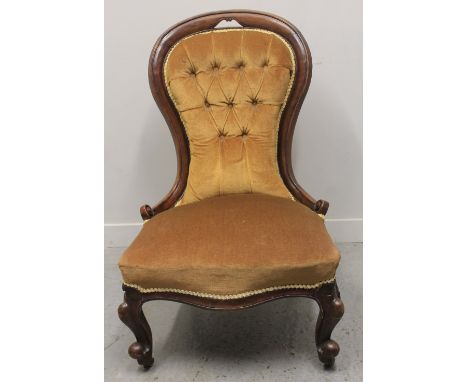 LATE VICTORIAN WALNUT FRAMED, SPOON BACKED LADIES FIRESIDE CHAIR, having buttoned back, stuff over serpentine seat on cabriol