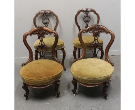 PAIR OF VICTORIAN MAHOGANY, SPOON BACKED LOW NURSING CHAIRS, having foliate moulded, pierced splats, circular stuff over seat