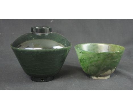 A CHINESE SPINACH JADE BOWL on raised foot.  10.5cm diameter together with another spinach jade bowl with lipped rim and cove