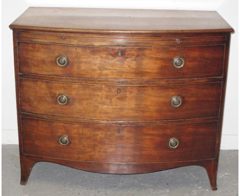 EARLY 19TH CENTURY MAHOGANY BOW FRONTED CHEST of three long graduated cock beaded drawers under a cock beaded brushing slide 