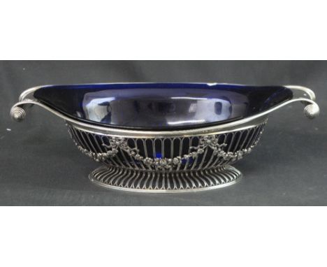 EDWARD VII SILVER PIERCED OVAL FRUIT BOWL with reeded border, scrolled handles and bow and swag decoration raised on an oval 