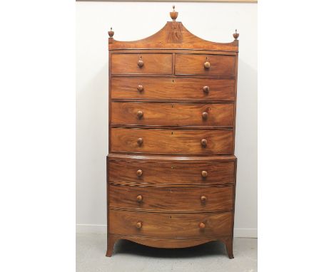 EARLY 19TH CENTURY MAHOGANY BOW FRONTED TALLBOY CHEST UPON CHEST, having architectural pediment with turned, urn shaped finia