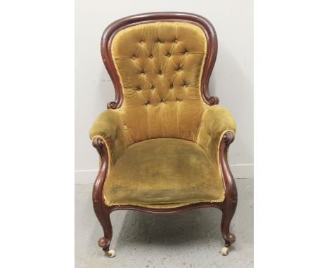 VICTORIAN MAHOGANY SHOW FRAME, SPOON BACKED GENTLEMAN'S FIRESIDE CHAIR, having buttoned upholstery, scrolled arms and serpent