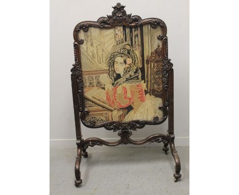 LARGE VICTORIAN ROSEWOOD FOLIATE SHOW FRAME FIRE SCREEN with Berlin woolwork tapestry portrait banner, with four outswept scr