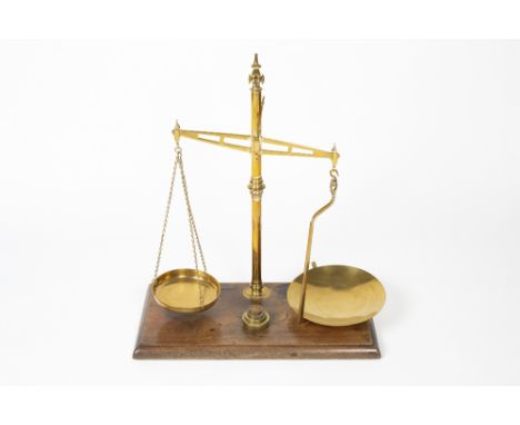 Mahogany and brass balance scales by W &amp; T Avery of Birmingham, on a mahogany base with various weights, 62cm across, 68c