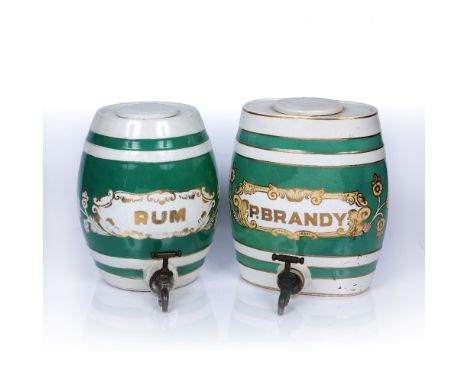 Two ceramic kegs  with green and white striped decoration, 'P. Brandy' and 'Rum', both taps are marked J. A. Cox, Old Compton