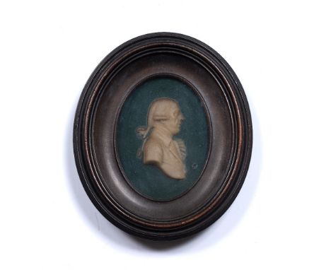 Oval wax miniature 19th Century, depicting a bewigged gentleman, in original frame and with indistinct label Condition: light