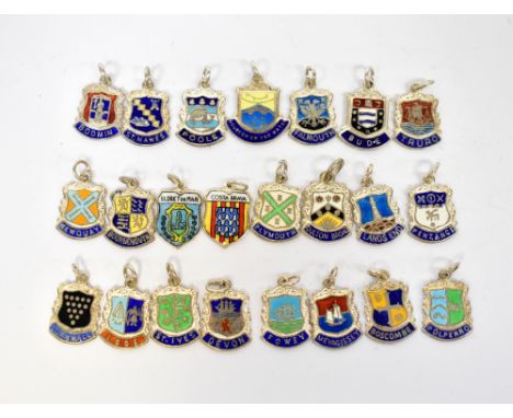 A collection of twenty-three various silver and enamel place name badges to include Lands End, St. Ives, Bourton-on-the-Water