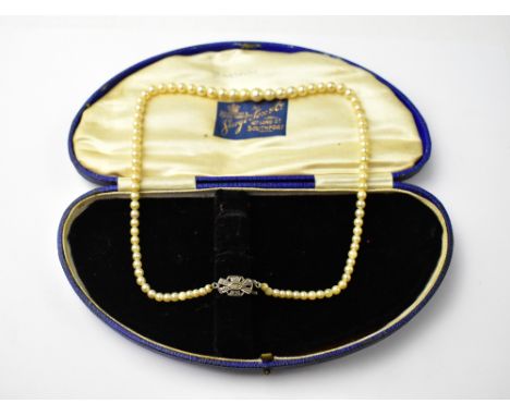 A single-strand cultured pearl necklace with white metal and white stone clasp, in a vintage George Fox &amp; Co satin lined 