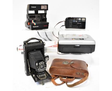 A small quantity of film cameras to include a Polaroid 635CL, a Canon Topshot, a Kodak Jr No.1 Autographic in case and a Koda
