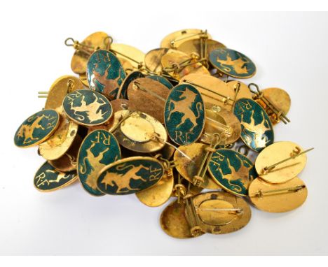 Fifty gilt metal and green enamel unicorn badges. 