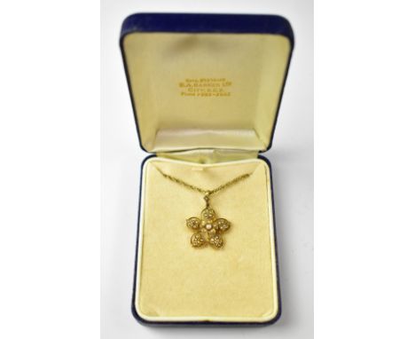 An Edwardian seed pearl floral necklace pendant, in a yellow metal mount, on a 9ct gold necklace with safety chain, length ap