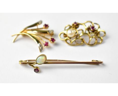 A collection of vintage gold brooches to include a 9ct gold bar brooch with a bezel set white oval opal and red stone, a 9ct 