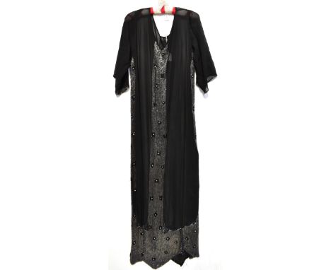 A circa 1930s full-length black silk chiffon beaded dress, with bead trim to the short sleeves, central panel to the back and