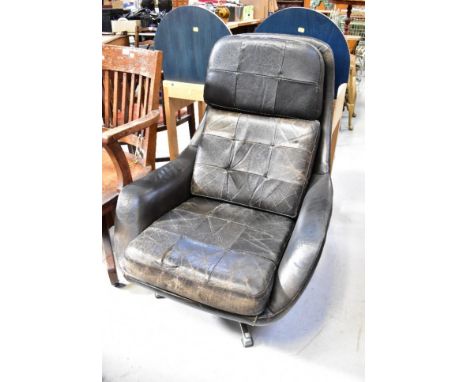 A mid-20th century retro leather upholstered swivel armchair with button back seat, cushion and backrest, in need of restorat