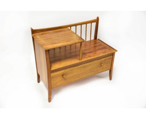 CHIPPY HEATH FURNITURE; a vintage 1960s teak telephone seat, with stick back decoration above a single long drawer, raised on